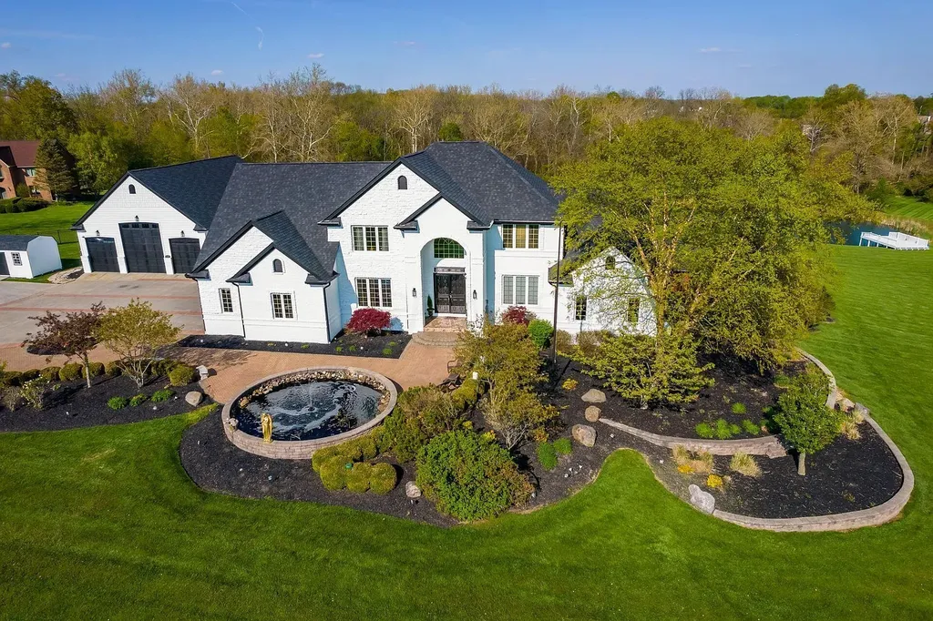 12100 Toll Gate Court NW Home in Pickerington, Ohio. Discover an entertainer's dream with this extraordinary 19.66 acre estate boasting over 16,000 square feet of living space. Immerse yourself in serene surroundings, including a creek, pond, and lush wooded areas, all complemented by a 6-car garage. Indulge in the opulent charm of the 6-bedroom, 6.5-bathroom main house, along with a separate 3-bedroom, 2-bathroom guest house. 