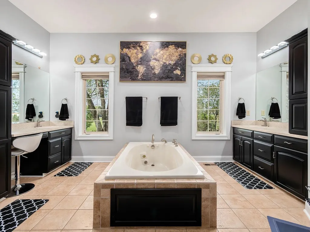 12100 Toll Gate Court NW Home in Pickerington, Ohio. Discover an entertainer's dream with this extraordinary 19.66 acre estate boasting over 16,000 square feet of living space. Immerse yourself in serene surroundings, including a creek, pond, and lush wooded areas, all complemented by a 6-car garage. Indulge in the opulent charm of the 6-bedroom, 6.5-bathroom main house, along with a separate 3-bedroom, 2-bathroom guest house. 