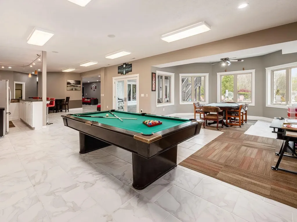 12100 Toll Gate Court NW Home in Pickerington, Ohio. Discover an entertainer's dream with this extraordinary 19.66 acre estate boasting over 16,000 square feet of living space. Immerse yourself in serene surroundings, including a creek, pond, and lush wooded areas, all complemented by a 6-car garage. Indulge in the opulent charm of the 6-bedroom, 6.5-bathroom main house, along with a separate 3-bedroom, 2-bathroom guest house. 