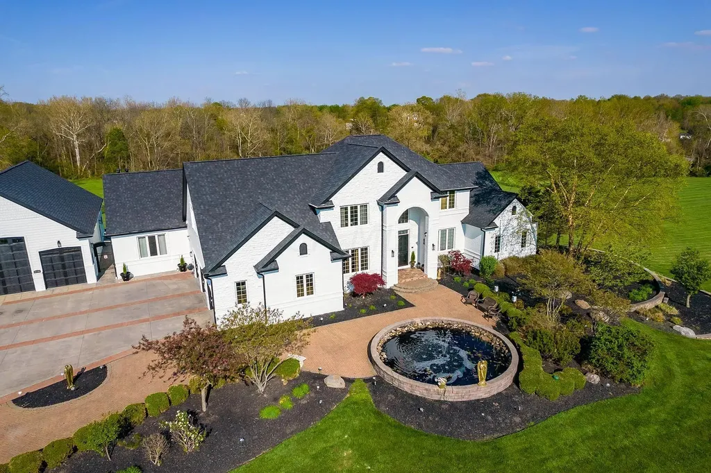 12100 Toll Gate Court NW Home in Pickerington, Ohio. Discover an entertainer's dream with this extraordinary 19.66 acre estate boasting over 16,000 square feet of living space. Immerse yourself in serene surroundings, including a creek, pond, and lush wooded areas, all complemented by a 6-car garage. Indulge in the opulent charm of the 6-bedroom, 6.5-bathroom main house, along with a separate 3-bedroom, 2-bathroom guest house. 