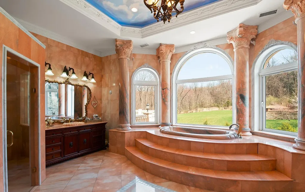 1284 Eagle Road Home in New Hope, Pennsylvania. Prepare to be mesmerized by this extraordinary palatial estate home nestled in the highly sought-after Upper Makefield area of Bucks County. Poised on 11+ acres and seamlessly integrated into the hillside of Jericho Mountain, this remarkable residence spans over 19,000 square feet, offering a level of detail and amenities that are truly unparalleled. A stunning example of French European architecture, this one-of-a-kind mansion boasts a myriad of exquisite features and finishes that will leave you in awe.