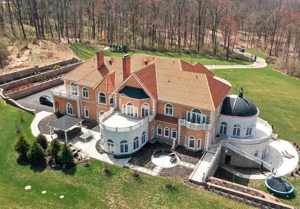 1284 Eagle Road Home in New Hope, Pennsylvania. Prepare to be mesmerized by this extraordinary palatial estate home nestled in the highly sought-after Upper Makefield area of Bucks County. Poised on 11+ acres and seamlessly integrated into the hillside of Jericho Mountain, this remarkable residence spans over 19,000 square feet, offering a level of detail and amenities that are truly unparalleled. A stunning example of French European architecture, this one-of-a-kind mansion boasts a myriad of exquisite features and finishes that will leave you in awe.