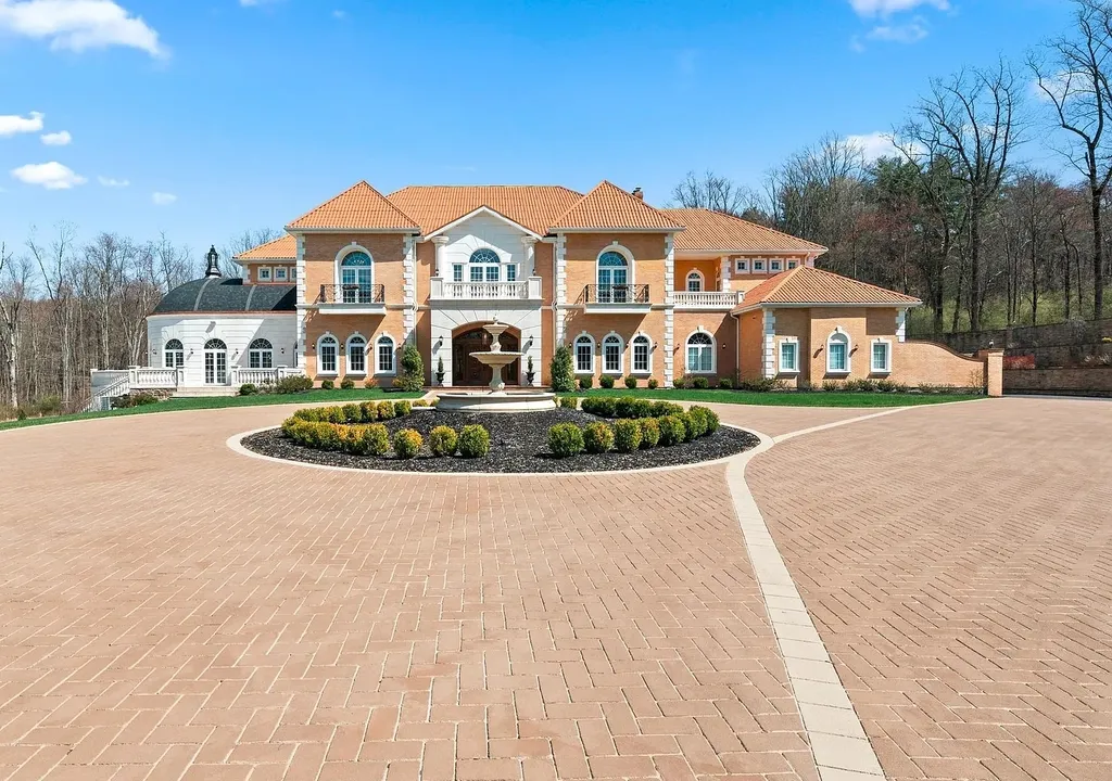 1284 Eagle Road Home in New Hope, Pennsylvania. Prepare to be mesmerized by this extraordinary palatial estate home nestled in the highly sought-after Upper Makefield area of Bucks County. Poised on 11+ acres and seamlessly integrated into the hillside of Jericho Mountain, this remarkable residence spans over 19,000 square feet, offering a level of detail and amenities that are truly unparalleled. A stunning example of French European architecture, this one-of-a-kind mansion boasts a myriad of exquisite features and finishes that will leave you in awe.