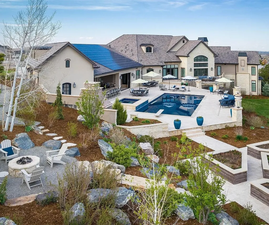15490 Mountain View Circle Home in Broomfield, Colorado. Discover a one-of-a-kind contemporary custom home nestled on 2.34 acres, offering breathtaking mountain views and sleek designer elements. This thoughtfully designed lifestyle compound boasts unrivaled exclusivity, featuring a garage for 10 cars, a year-round saltwater pool, an outdoor kitchen, a finished basement with a shooting range and golf simulator, and much more. With impeccable construction and attention to detail, this turnkey home offers the epitome of luxurious living.