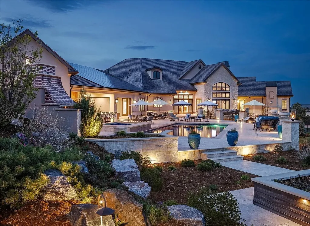 15490 Mountain View Circle Home in Broomfield, Colorado. Discover a one-of-a-kind contemporary custom home nestled on 2.34 acres, offering breathtaking mountain views and sleek designer elements. This thoughtfully designed lifestyle compound boasts unrivaled exclusivity, featuring a garage for 10 cars, a year-round saltwater pool, an outdoor kitchen, a finished basement with a shooting range and golf simulator, and much more. With impeccable construction and attention to detail, this turnkey home offers the epitome of luxurious living.