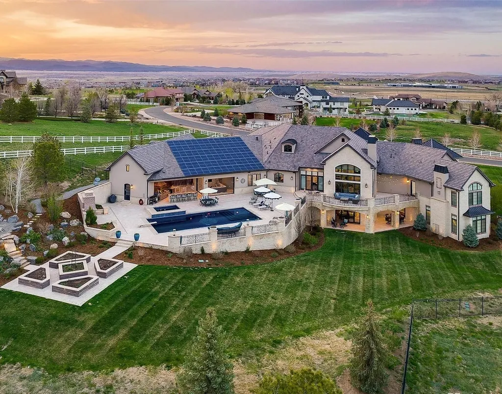 15490 Mountain View Circle Home in Broomfield, Colorado. Discover a one-of-a-kind contemporary custom home nestled on 2.34 acres, offering breathtaking mountain views and sleek designer elements. This thoughtfully designed lifestyle compound boasts unrivaled exclusivity, featuring a garage for 10 cars, a year-round saltwater pool, an outdoor kitchen, a finished basement with a shooting range and golf simulator, and much more. With impeccable construction and attention to detail, this turnkey home offers the epitome of luxurious living.
