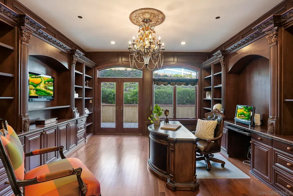 Elevated on a hill in Blossom Valley, this exquisite home offers a living experience that is truly unmatched. Nestled within a gated estate, the property expands across six acres of meticulously landscaped grounds, showcasing natural rock formations and a vibrant variety of palm trees, succulents, and blooming flowers. Embracing eco-friendly features such as a ground-water well and solar panels, this residence seamlessly blends sustainability with luxurious living. 15987 Broad Oaks Road Home in El Cajon, California.