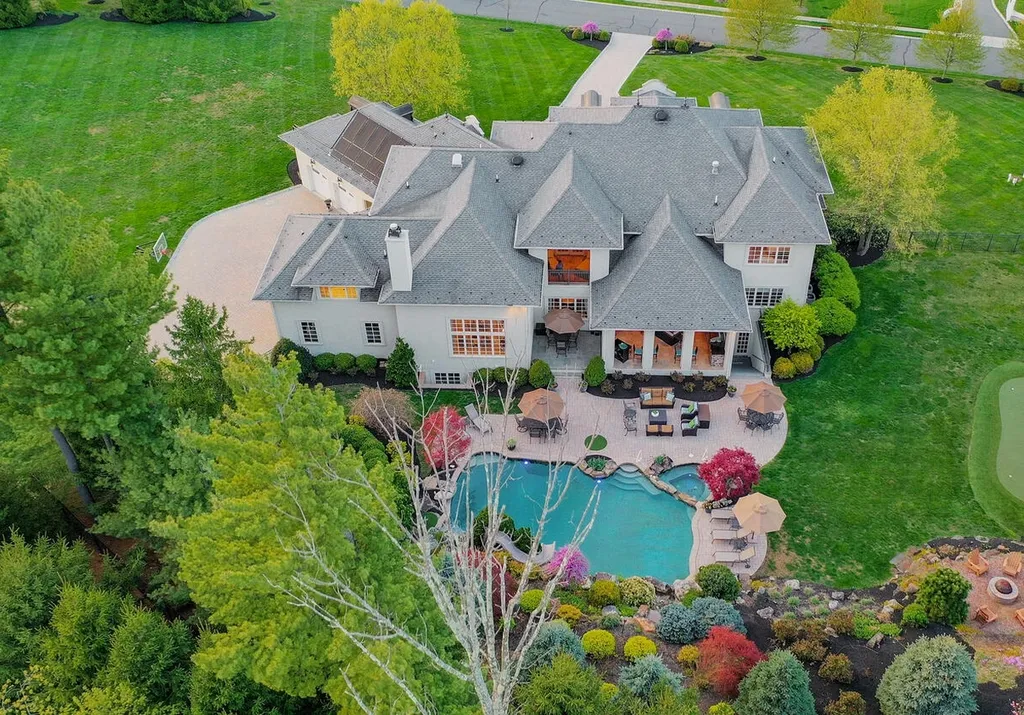 16 Tall Timber Lane Home in Bernards Township, New Jersey. Discover an extraordinary French Chateau-inspired property boasting nearly 12,000 sq ft of living space. This remarkable estate offers unparalleled luxury, featuring special amenities such as an elevator for easy accessibility, a first-floor guest suite, and radiant heated floors throughout, including the basement and garage. Indulge in the opulent 4,200 sq ft walk-out lower level, featuring high ceilings, a movie theater, expansive bar, gym, full spa bathroom with sauna, workshop, second laundry room, multiple entertainment areas, and potential for a sixth bedroom ensuite.