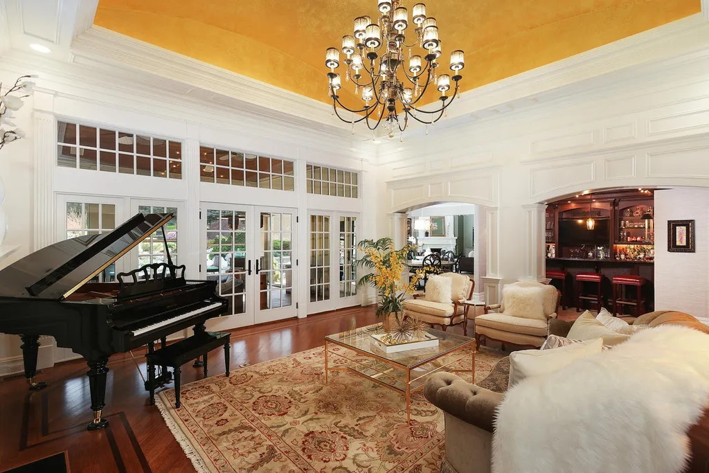 16 Tall Timber Lane Home in Bernards Township, New Jersey. Discover an extraordinary French Chateau-inspired property boasting nearly 12,000 sq ft of living space. This remarkable estate offers unparalleled luxury, featuring special amenities such as an elevator for easy accessibility, a first-floor guest suite, and radiant heated floors throughout, including the basement and garage. Indulge in the opulent 4,200 sq ft walk-out lower level, featuring high ceilings, a movie theater, expansive bar, gym, full spa bathroom with sauna, workshop, second laundry room, multiple entertainment areas, and potential for a sixth bedroom ensuite.