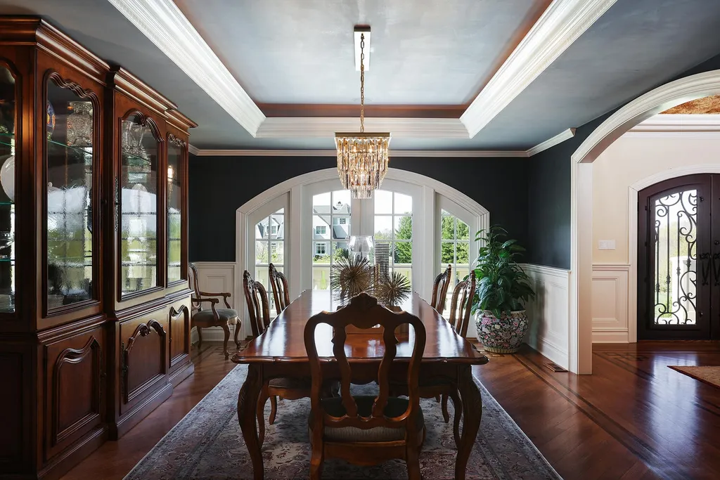 16 Tall Timber Lane Home in Bernards Township, New Jersey. Discover an extraordinary French Chateau-inspired property boasting nearly 12,000 sq ft of living space. This remarkable estate offers unparalleled luxury, featuring special amenities such as an elevator for easy accessibility, a first-floor guest suite, and radiant heated floors throughout, including the basement and garage. Indulge in the opulent 4,200 sq ft walk-out lower level, featuring high ceilings, a movie theater, expansive bar, gym, full spa bathroom with sauna, workshop, second laundry room, multiple entertainment areas, and potential for a sixth bedroom ensuite.