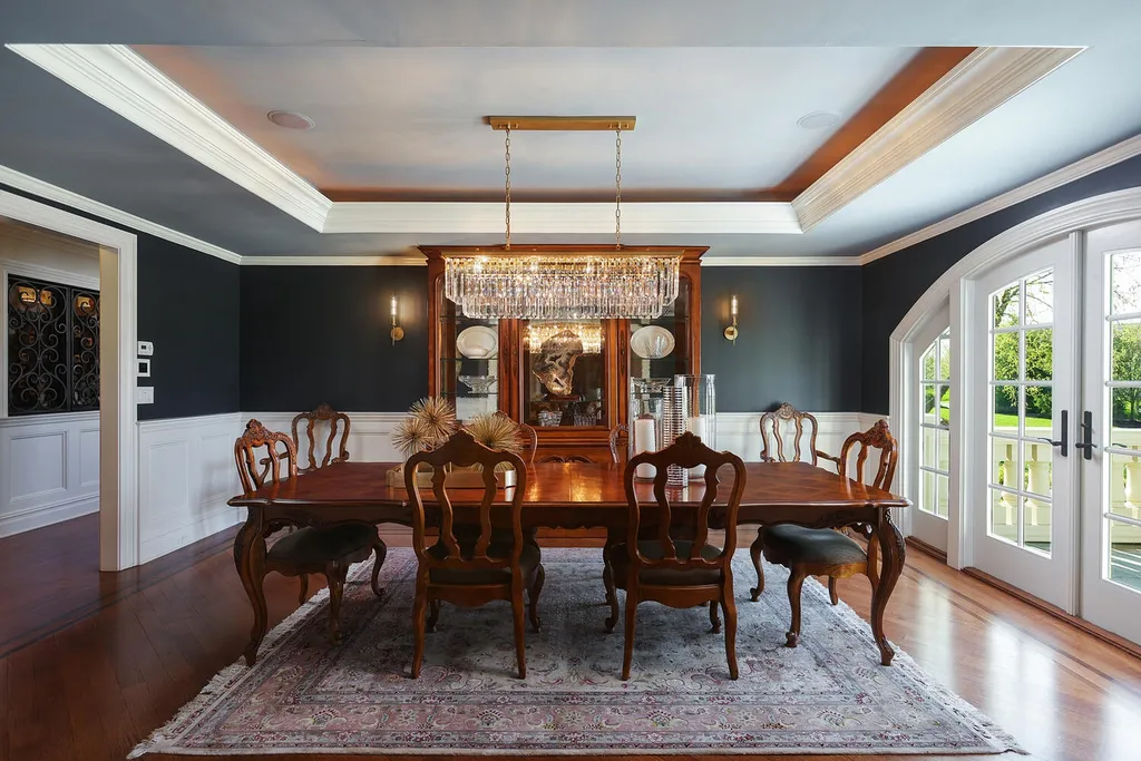 16 Tall Timber Lane Home in Bernards Township, New Jersey. Discover an extraordinary French Chateau-inspired property boasting nearly 12,000 sq ft of living space. This remarkable estate offers unparalleled luxury, featuring special amenities such as an elevator for easy accessibility, a first-floor guest suite, and radiant heated floors throughout, including the basement and garage. Indulge in the opulent 4,200 sq ft walk-out lower level, featuring high ceilings, a movie theater, expansive bar, gym, full spa bathroom with sauna, workshop, second laundry room, multiple entertainment areas, and potential for a sixth bedroom ensuite.