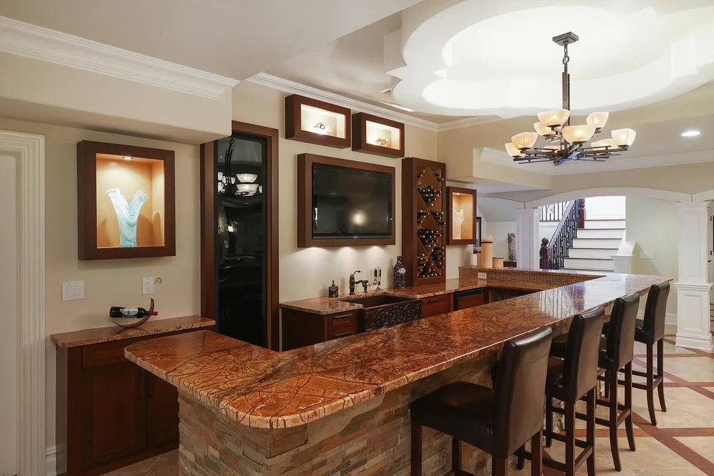 16 Tall Timber Lane Home in Bernards Township, New Jersey. Discover an extraordinary French Chateau-inspired property boasting nearly 12,000 sq ft of living space. This remarkable estate offers unparalleled luxury, featuring special amenities such as an elevator for easy accessibility, a first-floor guest suite, and radiant heated floors throughout, including the basement and garage. Indulge in the opulent 4,200 sq ft walk-out lower level, featuring high ceilings, a movie theater, expansive bar, gym, full spa bathroom with sauna, workshop, second laundry room, multiple entertainment areas, and potential for a sixth bedroom ensuite.