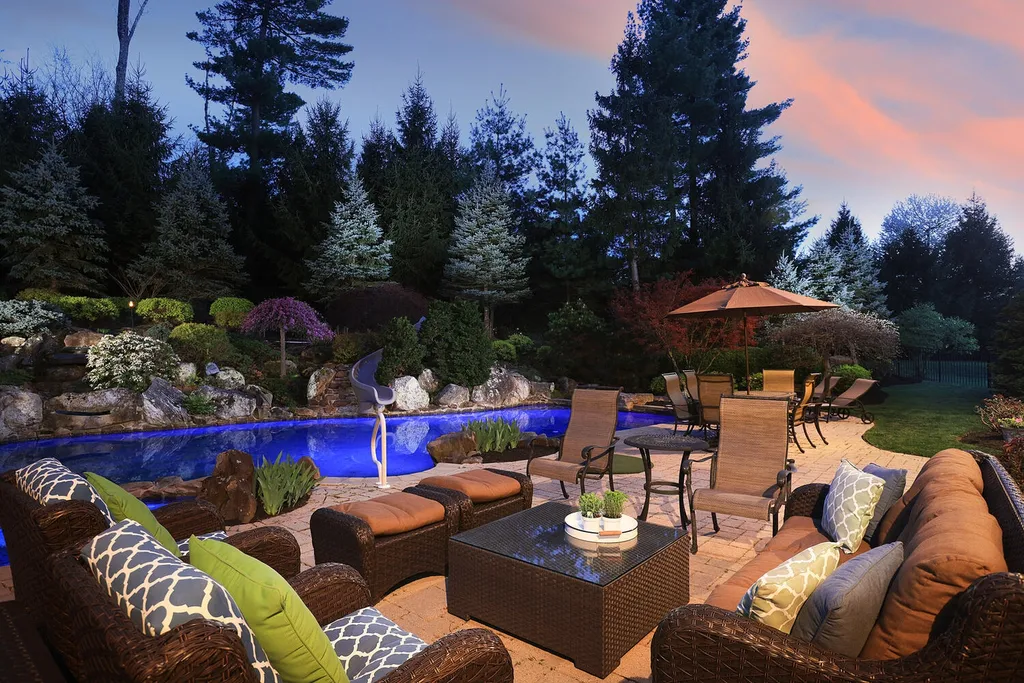 16 Tall Timber Lane Home in Bernards Township, New Jersey. Discover an extraordinary French Chateau-inspired property boasting nearly 12,000 sq ft of living space. This remarkable estate offers unparalleled luxury, featuring special amenities such as an elevator for easy accessibility, a first-floor guest suite, and radiant heated floors throughout, including the basement and garage. Indulge in the opulent 4,200 sq ft walk-out lower level, featuring high ceilings, a movie theater, expansive bar, gym, full spa bathroom with sauna, workshop, second laundry room, multiple entertainment areas, and potential for a sixth bedroom ensuite.
