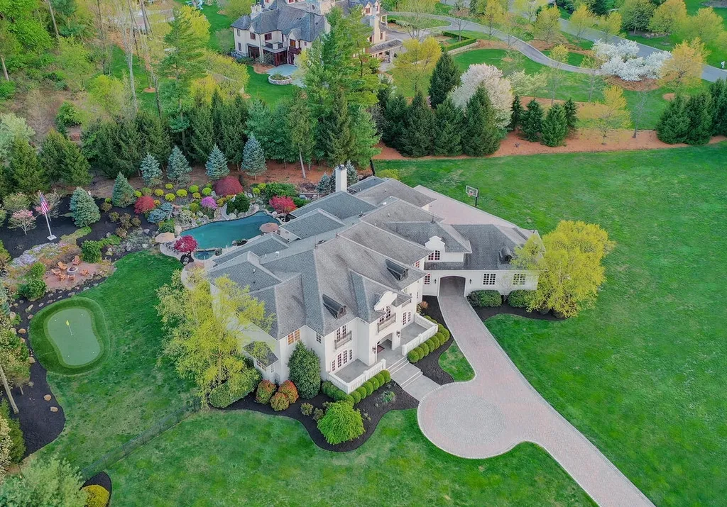 16 Tall Timber Lane Home in Bernards Township, New Jersey. Discover an extraordinary French Chateau-inspired property boasting nearly 12,000 sq ft of living space. This remarkable estate offers unparalleled luxury, featuring special amenities such as an elevator for easy accessibility, a first-floor guest suite, and radiant heated floors throughout, including the basement and garage. Indulge in the opulent 4,200 sq ft walk-out lower level, featuring high ceilings, a movie theater, expansive bar, gym, full spa bathroom with sauna, workshop, second laundry room, multiple entertainment areas, and potential for a sixth bedroom ensuite.