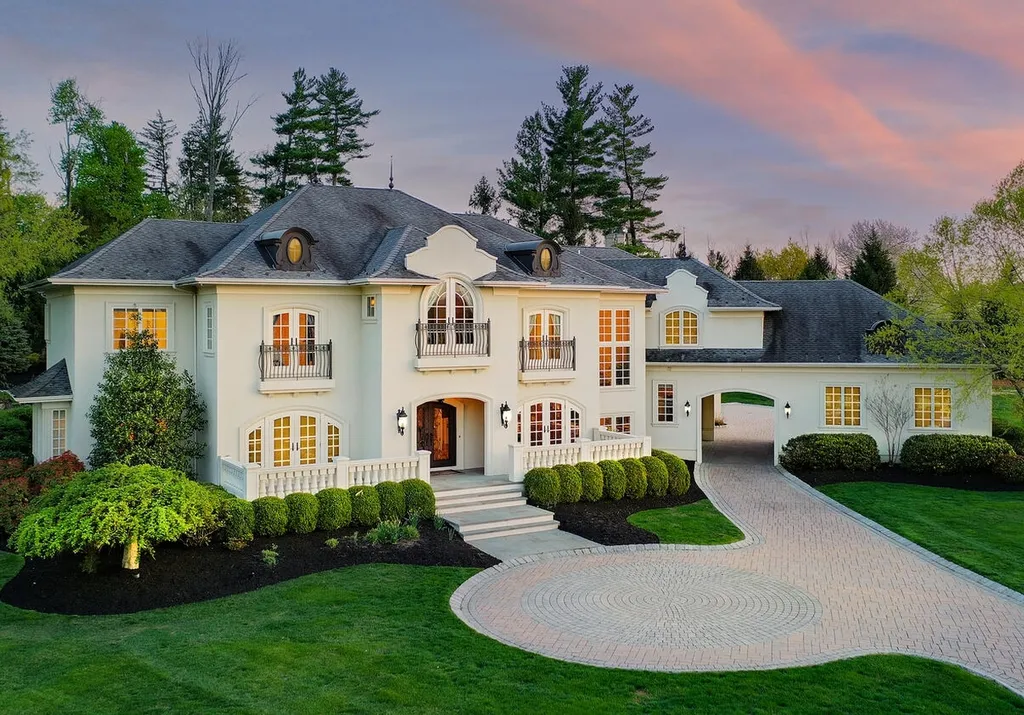 16 Tall Timber Lane Home in Bernards Township, New Jersey. Discover an extraordinary French Chateau-inspired property boasting nearly 12,000 sq ft of living space. This remarkable estate offers unparalleled luxury, featuring special amenities such as an elevator for easy accessibility, a first-floor guest suite, and radiant heated floors throughout, including the basement and garage. Indulge in the opulent 4,200 sq ft walk-out lower level, featuring high ceilings, a movie theater, expansive bar, gym, full spa bathroom with sauna, workshop, second laundry room, multiple entertainment areas, and potential for a sixth bedroom ensuite.
