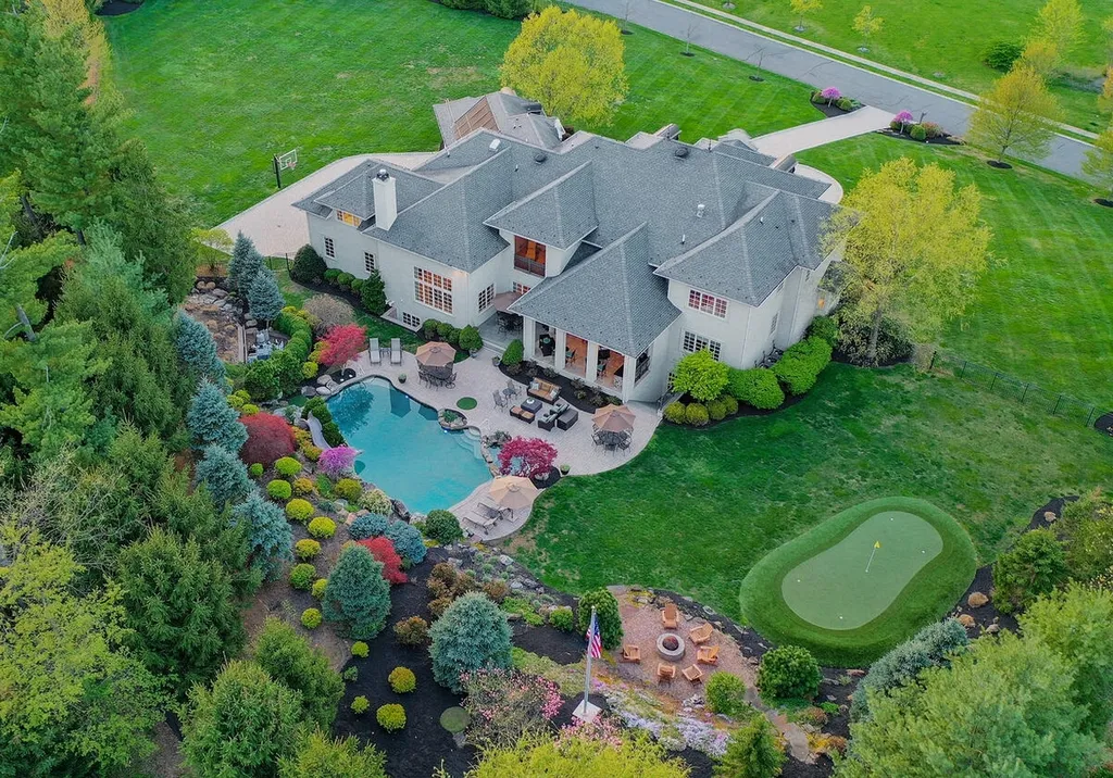 16 Tall Timber Lane Home in Bernards Township, New Jersey. Discover an extraordinary French Chateau-inspired property boasting nearly 12,000 sq ft of living space. This remarkable estate offers unparalleled luxury, featuring special amenities such as an elevator for easy accessibility, a first-floor guest suite, and radiant heated floors throughout, including the basement and garage. Indulge in the opulent 4,200 sq ft walk-out lower level, featuring high ceilings, a movie theater, expansive bar, gym, full spa bathroom with sauna, workshop, second laundry room, multiple entertainment areas, and potential for a sixth bedroom ensuite.