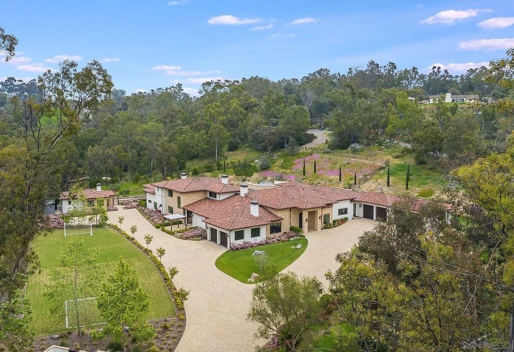 16109 Rambla De Las Flores Home in Rancho Santa Fe, California. The property is situated on 2.7 acres of land and features a detached guest house with a kitchen, as well as a master retreat with a private patio overlooking the pool, spa, and grounds. 
