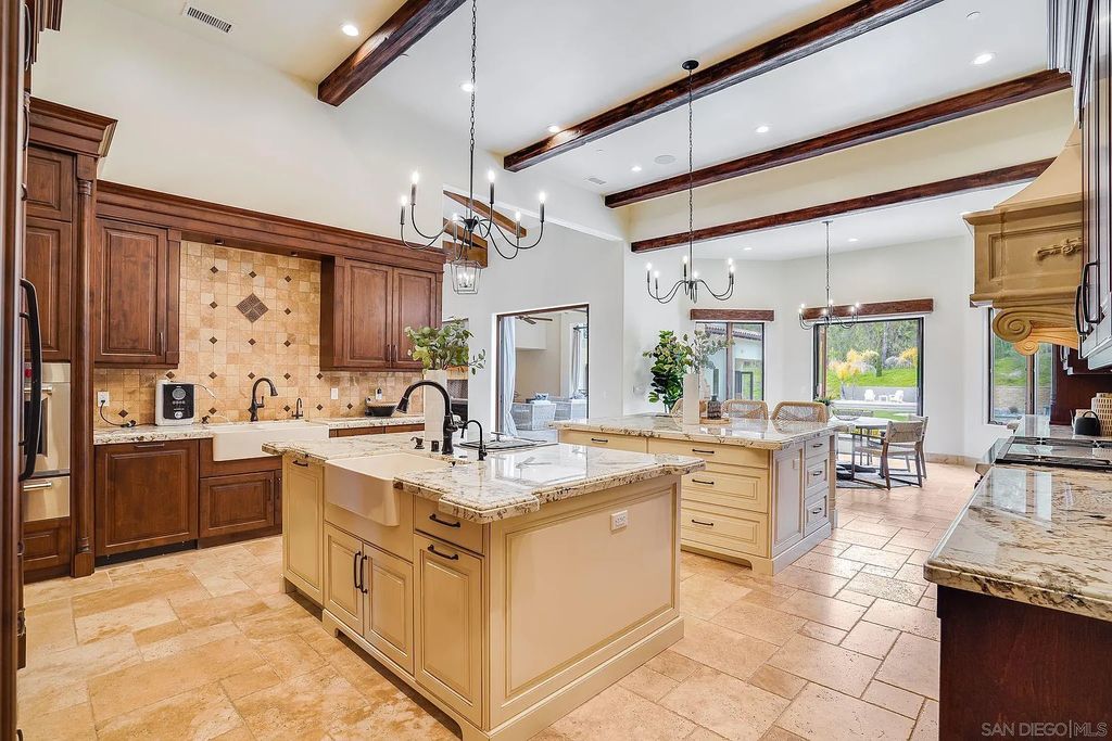 16109 Rambla De Las Flores Home in Rancho Santa Fe, California. The property is situated on 2.7 acres of land and features a detached guest house with a kitchen, as well as a master retreat with a private patio overlooking the pool, spa, and grounds. 