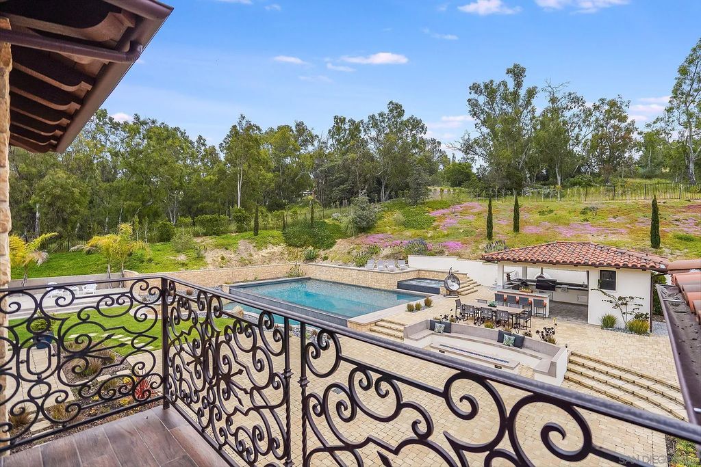 16109 Rambla De Las Flores Home in Rancho Santa Fe, California. The property is situated on 2.7 acres of land and features a detached guest house with a kitchen, as well as a master retreat with a private patio overlooking the pool, spa, and grounds. 