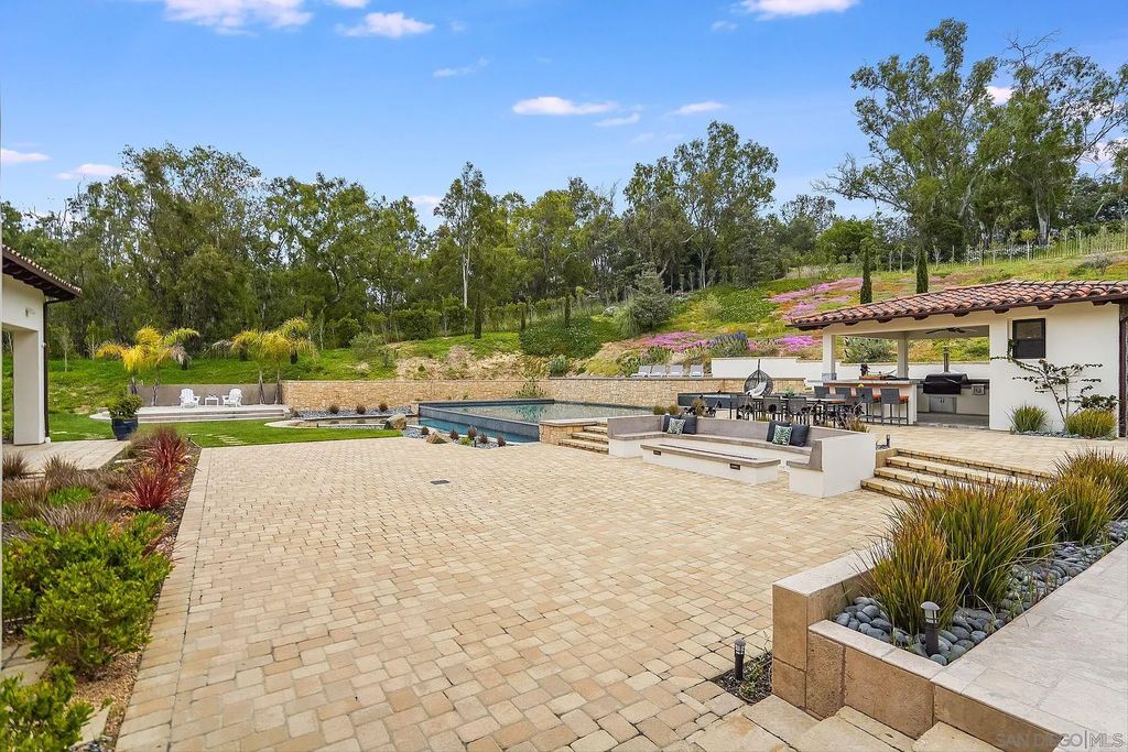 16109 Rambla De Las Flores Home in Rancho Santa Fe, California. The property is situated on 2.7 acres of land and features a detached guest house with a kitchen, as well as a master retreat with a private patio overlooking the pool, spa, and grounds. 