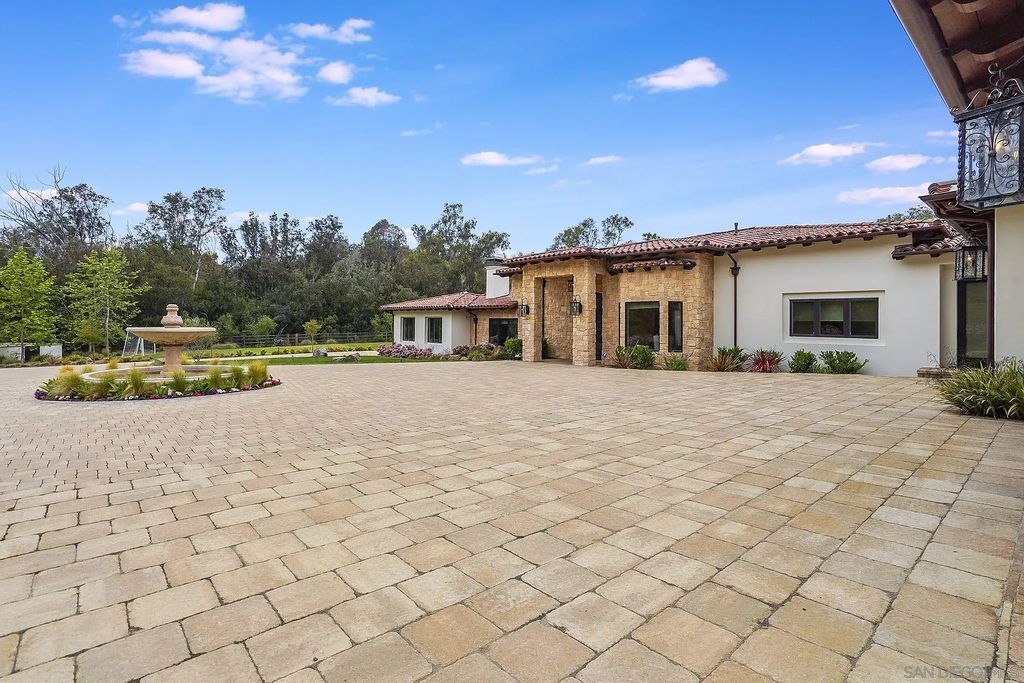 16109 Rambla De Las Flores Home in Rancho Santa Fe, California. The property is situated on 2.7 acres of land and features a detached guest house with a kitchen, as well as a master retreat with a private patio overlooking the pool, spa, and grounds. 