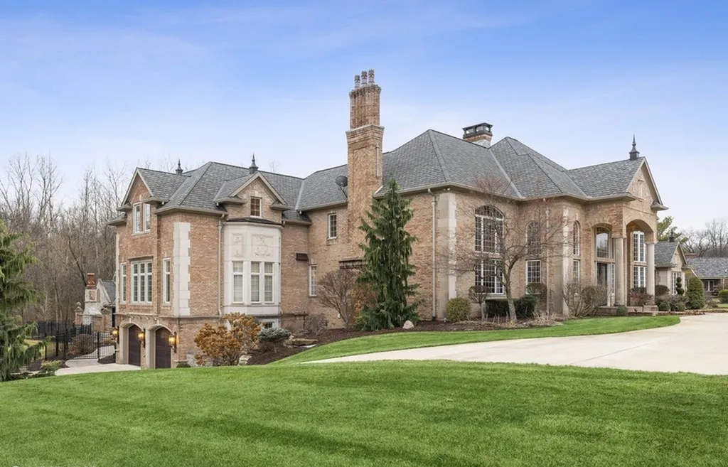 17540 Dublin Drive Home in Granger, Indiana. Experience the epitome of luxury in this magnificent 12,000+ square foot estate situated on a premier 2.65-acre lot with serene wooded views in the prestigious gated community of Shamrock Hills. Every detail of this gracious home showcases the finest materials and craftsmanship, resulting in an unparalleled living experience. Custom millwork, an elevator, and an array of exceptional features elevate this residence to the highest level of sophistication.