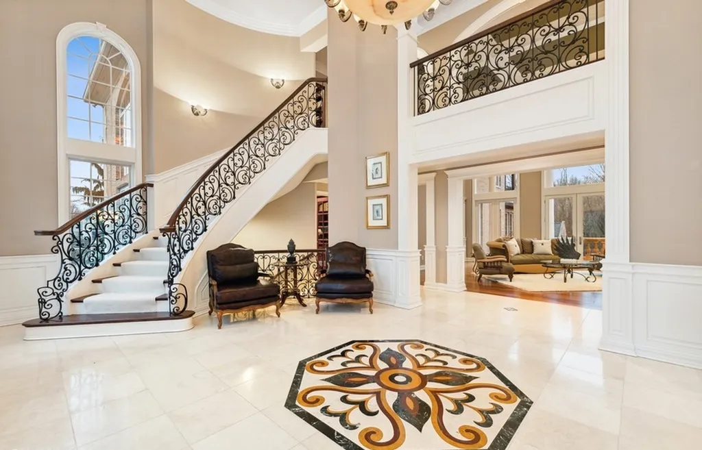 17540 Dublin Drive Home in Granger, Indiana. Experience the epitome of luxury in this magnificent 12,000+ square foot estate situated on a premier 2.65-acre lot with serene wooded views in the prestigious gated community of Shamrock Hills. Every detail of this gracious home showcases the finest materials and craftsmanship, resulting in an unparalleled living experience. Custom millwork, an elevator, and an array of exceptional features elevate this residence to the highest level of sophistication.