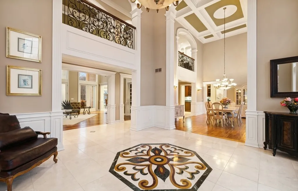 17540 Dublin Drive Home in Granger, Indiana. Experience the epitome of luxury in this magnificent 12,000+ square foot estate situated on a premier 2.65-acre lot with serene wooded views in the prestigious gated community of Shamrock Hills. Every detail of this gracious home showcases the finest materials and craftsmanship, resulting in an unparalleled living experience. Custom millwork, an elevator, and an array of exceptional features elevate this residence to the highest level of sophistication.