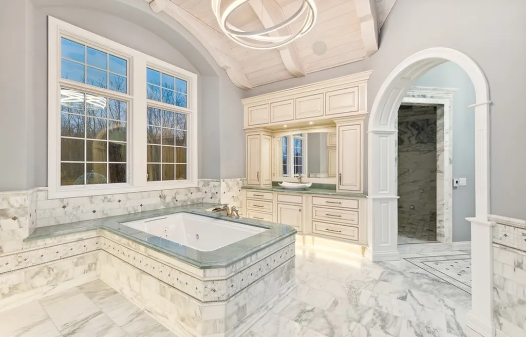 17540 Dublin Drive Home in Granger, Indiana. Experience the epitome of luxury in this magnificent 12,000+ square foot estate situated on a premier 2.65-acre lot with serene wooded views in the prestigious gated community of Shamrock Hills. Every detail of this gracious home showcases the finest materials and craftsmanship, resulting in an unparalleled living experience. Custom millwork, an elevator, and an array of exceptional features elevate this residence to the highest level of sophistication.