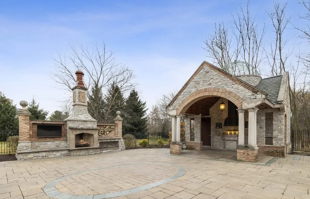 17540 Dublin Drive Home in Granger, Indiana. Experience the epitome of luxury in this magnificent 12,000+ square foot estate situated on a premier 2.65-acre lot with serene wooded views in the prestigious gated community of Shamrock Hills. Every detail of this gracious home showcases the finest materials and craftsmanship, resulting in an unparalleled living experience. Custom millwork, an elevator, and an array of exceptional features elevate this residence to the highest level of sophistication.