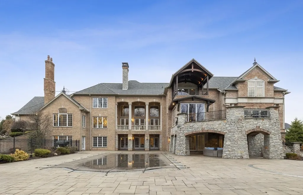 17540 Dublin Drive Home in Granger, Indiana. Experience the epitome of luxury in this magnificent 12,000+ square foot estate situated on a premier 2.65-acre lot with serene wooded views in the prestigious gated community of Shamrock Hills. Every detail of this gracious home showcases the finest materials and craftsmanship, resulting in an unparalleled living experience. Custom millwork, an elevator, and an array of exceptional features elevate this residence to the highest level of sophistication.