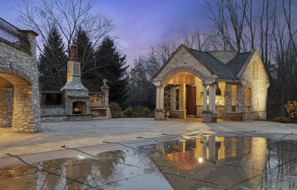 17540 Dublin Drive Home in Granger, Indiana. Experience the epitome of luxury in this magnificent 12,000+ square foot estate situated on a premier 2.65-acre lot with serene wooded views in the prestigious gated community of Shamrock Hills. Every detail of this gracious home showcases the finest materials and craftsmanship, resulting in an unparalleled living experience. Custom millwork, an elevator, and an array of exceptional features elevate this residence to the highest level of sophistication.