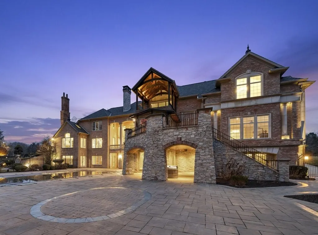 17540 Dublin Drive Home in Granger, Indiana. Experience the epitome of luxury in this magnificent 12,000+ square foot estate situated on a premier 2.65-acre lot with serene wooded views in the prestigious gated community of Shamrock Hills. Every detail of this gracious home showcases the finest materials and craftsmanship, resulting in an unparalleled living experience. Custom millwork, an elevator, and an array of exceptional features elevate this residence to the highest level of sophistication.