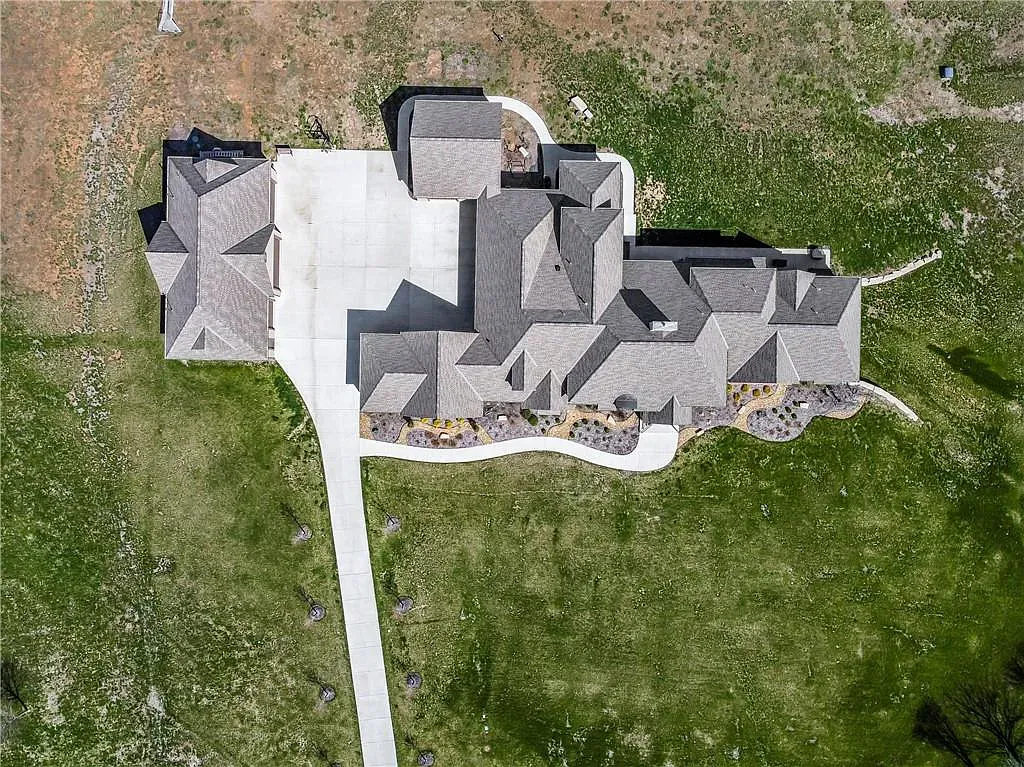 18111 Melrose Drive Home in Overland Park, Kansas. Stunning estate property situated on nearly 8 acres in the coveted Wolf Valley. With over 7600 square feet of living space and an astounding 12 garage spaces, this property offers everything you could ever need.