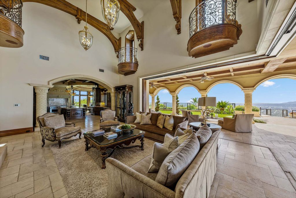 1903 Saxton Lane Home in El Cajon, California. Discover unparalleled luxury living in this custom-built, handcrafted mountaintop estate with unobstructed views. Designed by renowned architect John Jensen AIA and built by Tony Mezain AME Proline Inc, this 13,631 sqft retreat features 5 bedrooms, 9 bathrooms, and exquisite attention to detail. 