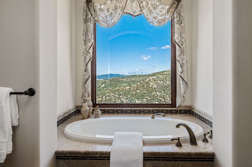 1903 Saxton Lane Home in El Cajon, California. Discover unparalleled luxury living in this custom-built, handcrafted mountaintop estate with unobstructed views. Designed by renowned architect John Jensen AIA and built by Tony Mezain AME Proline Inc, this 13,631 sqft retreat features 5 bedrooms, 9 bathrooms, and exquisite attention to detail. 