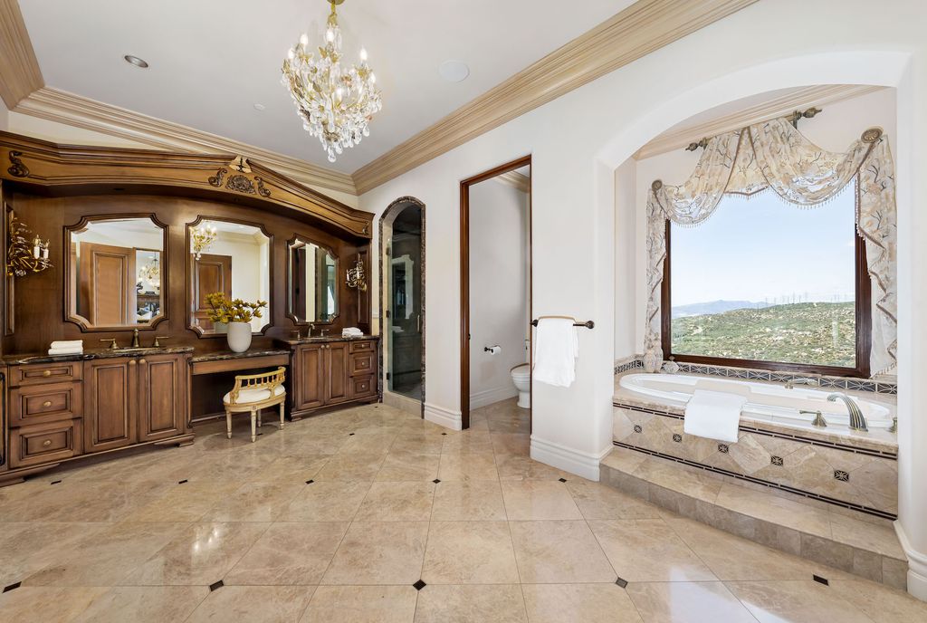 1903 Saxton Lane Home in El Cajon, California. Discover unparalleled luxury living in this custom-built, handcrafted mountaintop estate with unobstructed views. Designed by renowned architect John Jensen AIA and built by Tony Mezain AME Proline Inc, this 13,631 sqft retreat features 5 bedrooms, 9 bathrooms, and exquisite attention to detail. 