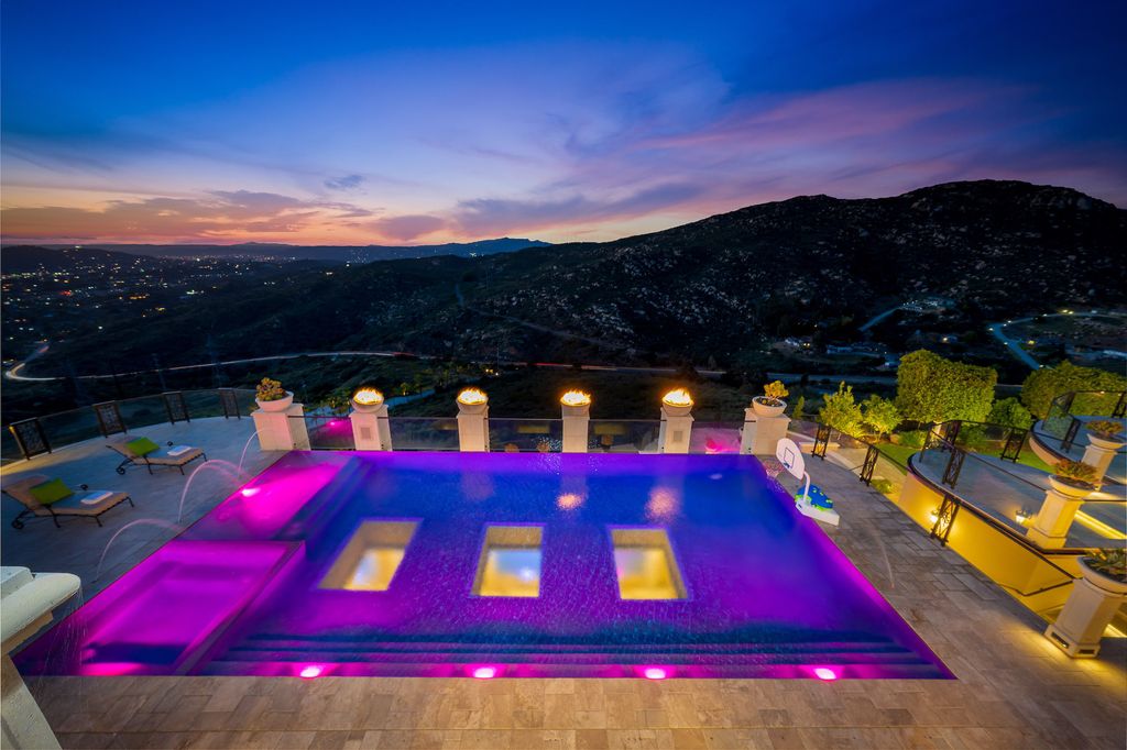 1903 Saxton Lane Home in El Cajon, California. Discover unparalleled luxury living in this custom-built, handcrafted mountaintop estate with unobstructed views. Designed by renowned architect John Jensen AIA and built by Tony Mezain AME Proline Inc, this 13,631 sqft retreat features 5 bedrooms, 9 bathrooms, and exquisite attention to detail. 
