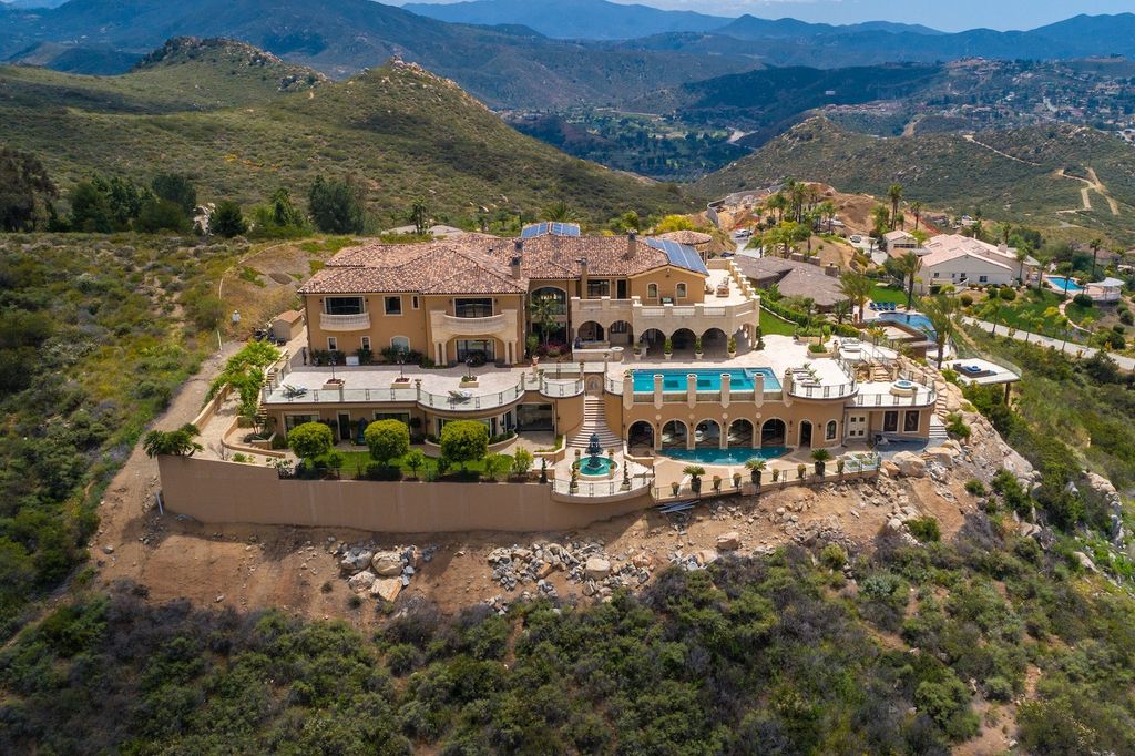 1903 Saxton Lane Home in El Cajon, California. Discover unparalleled luxury living in this custom-built, handcrafted mountaintop estate with unobstructed views. Designed by renowned architect John Jensen AIA and built by Tony Mezain AME Proline Inc, this 13,631 sqft retreat features 5 bedrooms, 9 bathrooms, and exquisite attention to detail. 