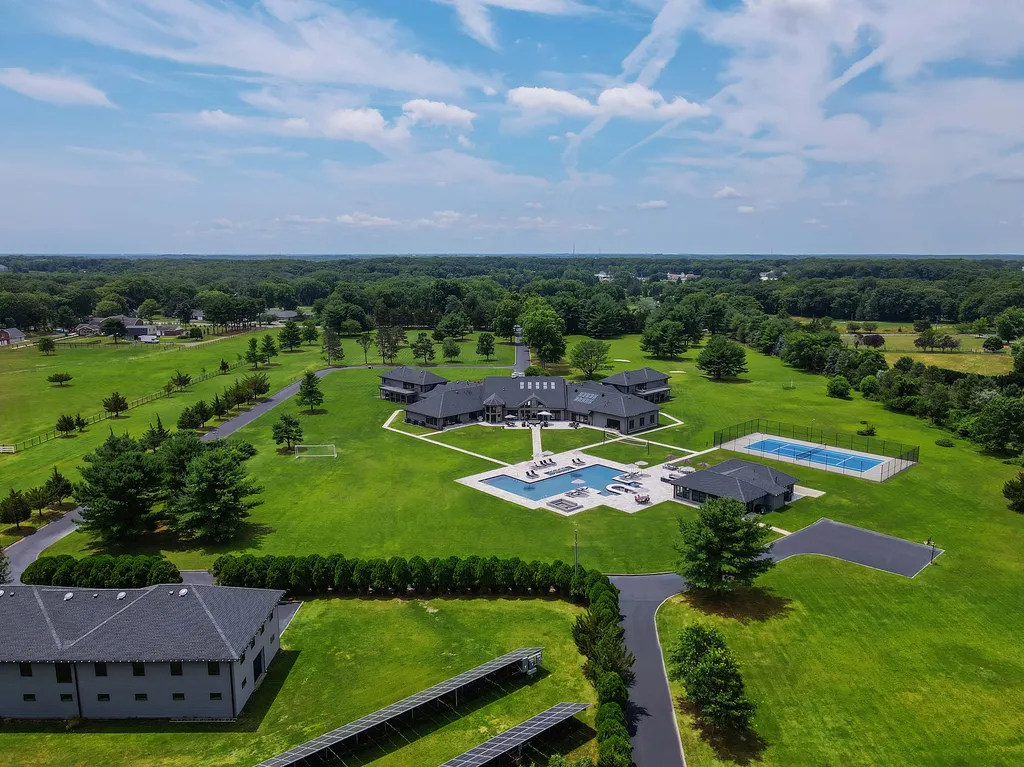 1980 Campbell Road Home in Wall, New Jersey. Experience the epitome of luxury living at Mattaccino, a remarkable 23.44 acre residential resort that surpasses all expectations. Discover a sprawling 32,500 square-foot compound, featuring an impressive array of amenities, including 10+ bedrooms, 17 bathrooms, a four-hole golf course, equestrian stables, an ultra-chic underground nightclub, and an indoor pool and spa.