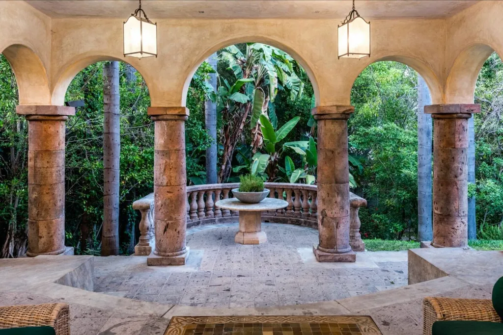 206 N Carolwood Drive Home in Los Angeles, California. Experience the epitome of luxurious living in this contemporary Tuscany-style estate nestled on the prestigious Carolwood Drive in prime Holmby Hills. Beyond the private gated entrance, this magnificent 10-bedroom, 10-bathroom residence awaits, surrounded by towering trees and lushly landscaped verdant grounds. Built with natural woods and imported stone, the home's romantic exterior seamlessly blends with the tranquil beauty of its surroundings.