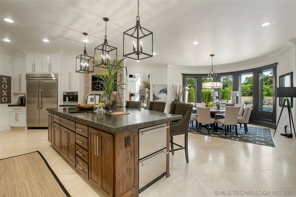 2411 E 34th Street Home in Tulsa, Oklahoma. Experience the epitome of luxury in this one-of-a-kind, majestic midtown mansion. Built in 2010, this stunning residence showcases high ceilings and bright, open rooms that overlook an incredible backyard oasis. Ideal for entertaining, the home features multiple game rooms, a theater, two gyms, a billiards room, and a cigar lounge with ventilation to the outside. Indulge in the 1,000-bottle wine room, relax by the spacious pool and spa, and enjoy outdoor dining with the convenient outdoor kitchen and covered living area.