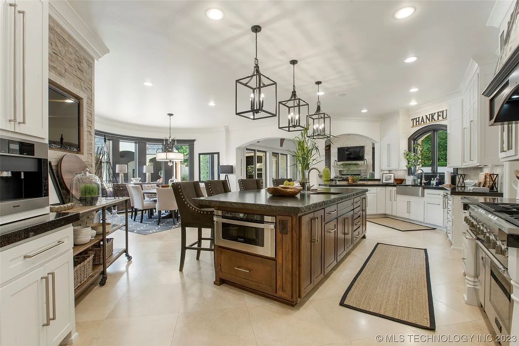 2411 E 34th Street Home in Tulsa, Oklahoma. Experience the epitome of luxury in this one-of-a-kind, majestic midtown mansion. Built in 2010, this stunning residence showcases high ceilings and bright, open rooms that overlook an incredible backyard oasis. Ideal for entertaining, the home features multiple game rooms, a theater, two gyms, a billiards room, and a cigar lounge with ventilation to the outside. Indulge in the 1,000-bottle wine room, relax by the spacious pool and spa, and enjoy outdoor dining with the convenient outdoor kitchen and covered living area.