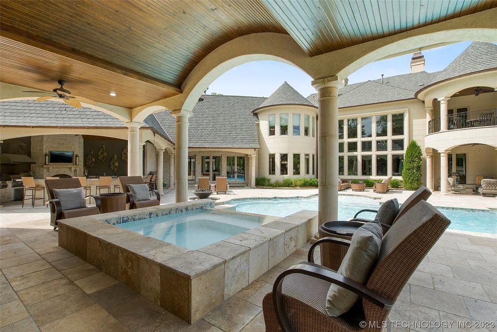2411 E 34th Street Home in Tulsa, Oklahoma. Experience the epitome of luxury in this one-of-a-kind, majestic midtown mansion. Built in 2010, this stunning residence showcases high ceilings and bright, open rooms that overlook an incredible backyard oasis. Ideal for entertaining, the home features multiple game rooms, a theater, two gyms, a billiards room, and a cigar lounge with ventilation to the outside. Indulge in the 1,000-bottle wine room, relax by the spacious pool and spa, and enjoy outdoor dining with the convenient outdoor kitchen and covered living area.