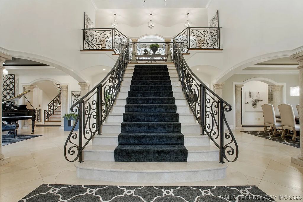 2411 E 34th Street Home in Tulsa, Oklahoma. Experience the epitome of luxury in this one-of-a-kind, majestic midtown mansion. Built in 2010, this stunning residence showcases high ceilings and bright, open rooms that overlook an incredible backyard oasis. Ideal for entertaining, the home features multiple game rooms, a theater, two gyms, a billiards room, and a cigar lounge with ventilation to the outside. Indulge in the 1,000-bottle wine room, relax by the spacious pool and spa, and enjoy outdoor dining with the convenient outdoor kitchen and covered living area.