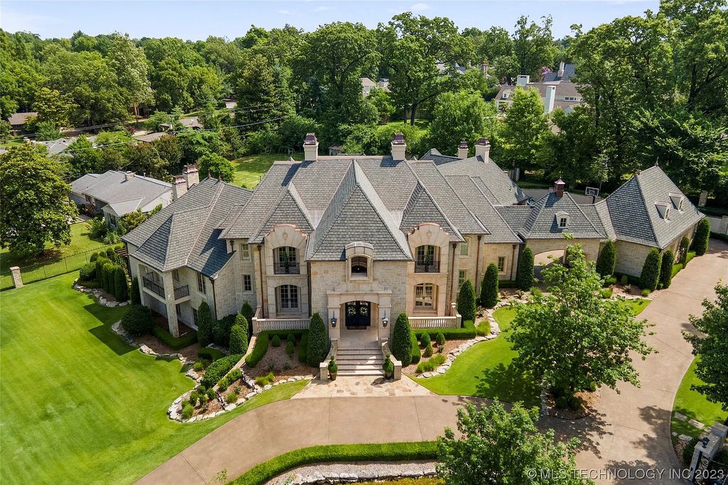 2411 E 34th Street Home in Tulsa, Oklahoma. Experience the epitome of luxury in this one-of-a-kind, majestic midtown mansion. Built in 2010, this stunning residence showcases high ceilings and bright, open rooms that overlook an incredible backyard oasis. Ideal for entertaining, the home features multiple game rooms, a theater, two gyms, a billiards room, and a cigar lounge with ventilation to the outside. Indulge in the 1,000-bottle wine room, relax by the spacious pool and spa, and enjoy outdoor dining with the convenient outdoor kitchen and covered living area.