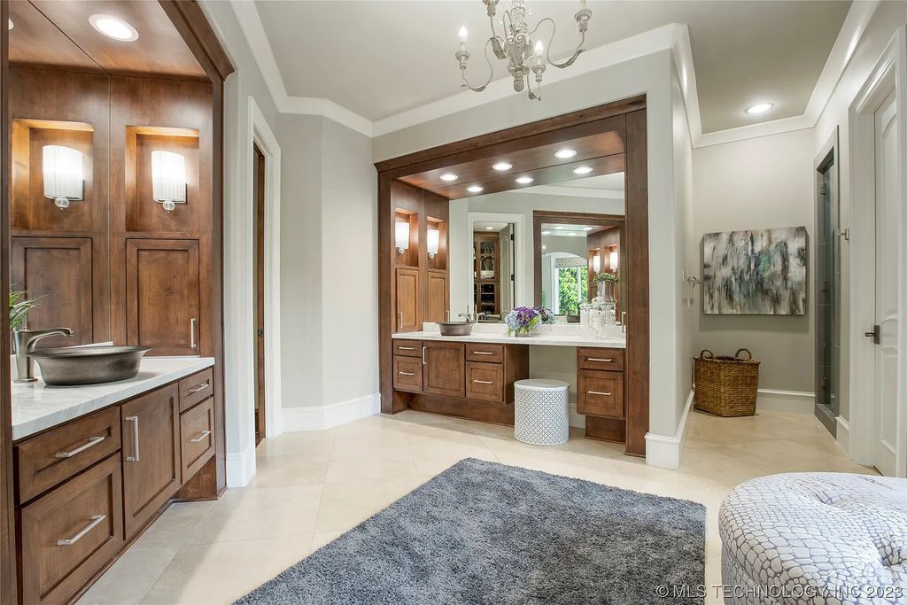 2411 E 34th Street Home in Tulsa, Oklahoma. Experience the epitome of luxury in this one-of-a-kind, majestic midtown mansion. Built in 2010, this stunning residence showcases high ceilings and bright, open rooms that overlook an incredible backyard oasis. Ideal for entertaining, the home features multiple game rooms, a theater, two gyms, a billiards room, and a cigar lounge with ventilation to the outside. Indulge in the 1,000-bottle wine room, relax by the spacious pool and spa, and enjoy outdoor dining with the convenient outdoor kitchen and covered living area.