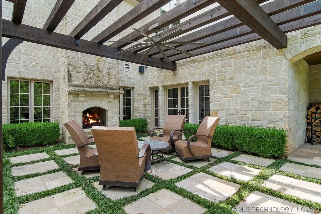 2411 E 34th Street Home in Tulsa, Oklahoma. Experience the epitome of luxury in this one-of-a-kind, majestic midtown mansion. Built in 2010, this stunning residence showcases high ceilings and bright, open rooms that overlook an incredible backyard oasis. Ideal for entertaining, the home features multiple game rooms, a theater, two gyms, a billiards room, and a cigar lounge with ventilation to the outside. Indulge in the 1,000-bottle wine room, relax by the spacious pool and spa, and enjoy outdoor dining with the convenient outdoor kitchen and covered living area.
