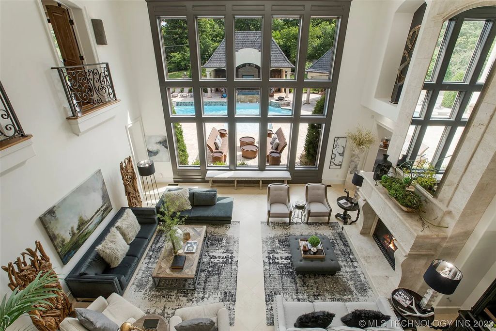 2411 E 34th Street Home in Tulsa, Oklahoma. Experience the epitome of luxury in this one-of-a-kind, majestic midtown mansion. Built in 2010, this stunning residence showcases high ceilings and bright, open rooms that overlook an incredible backyard oasis. Ideal for entertaining, the home features multiple game rooms, a theater, two gyms, a billiards room, and a cigar lounge with ventilation to the outside. Indulge in the 1,000-bottle wine room, relax by the spacious pool and spa, and enjoy outdoor dining with the convenient outdoor kitchen and covered living area.