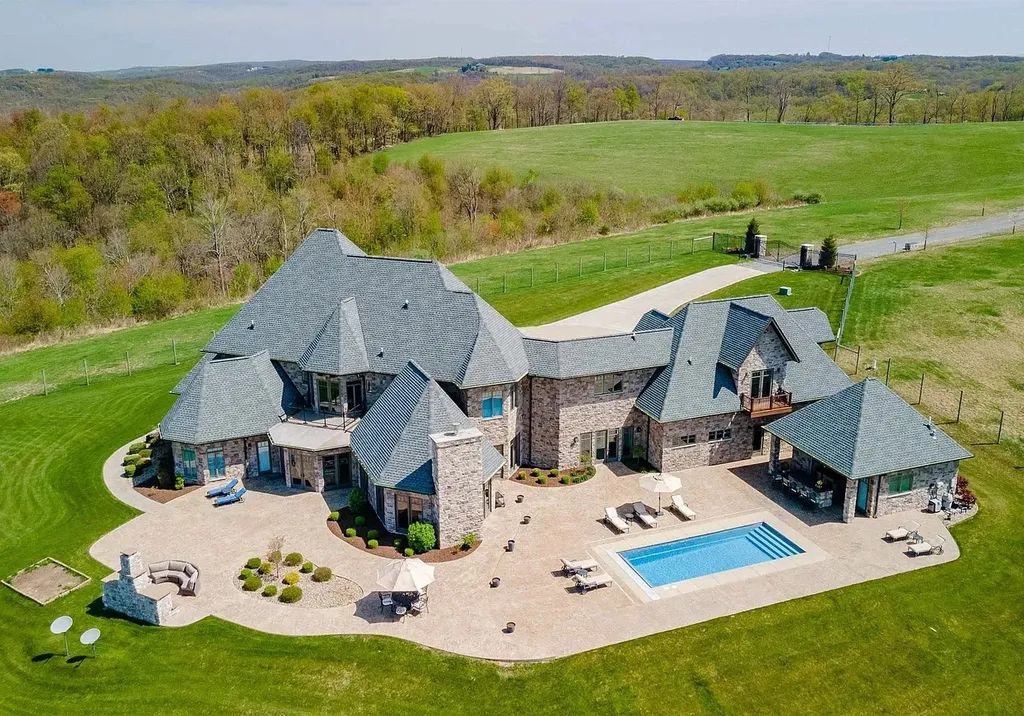 2536 Halleck Road Home in Morgantown, West Virginia. Discover the epitome of secluded luxury living with this sprawling estate nestled on 20+ acres of stunning West Virginia landscape. With over 9,500 square feet spread across three floors, this meticulously designed home offers 4 or 5 bedrooms, 5 full and 4 half bathrooms, and a refined color palette that sets the stage for elegant furnishings. The chef's kitchen features top-of-the-line Sub Zero and Wolf appliances, custom cabinetry, and a hidden walk-in pantry. 
